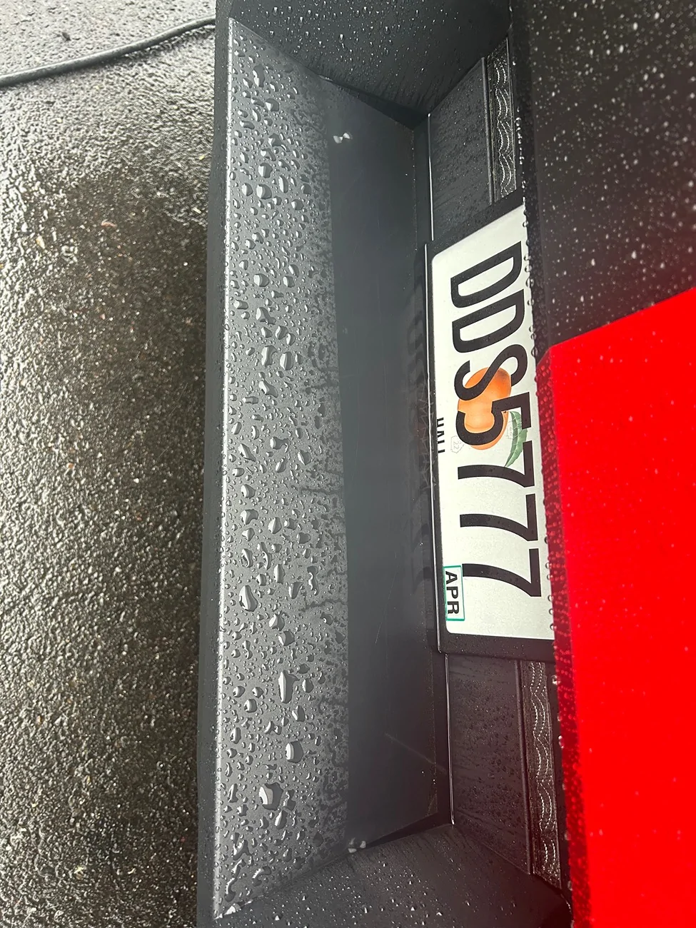 Tesla Cybertruck Water puddling on the rear bumper and license plate. IMG_0542