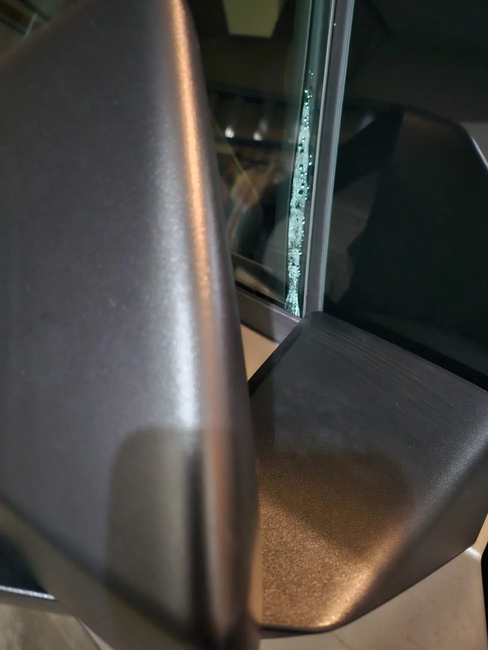 Tesla Cybertruck Water inside leading edge of front passenger window 20251030_214920