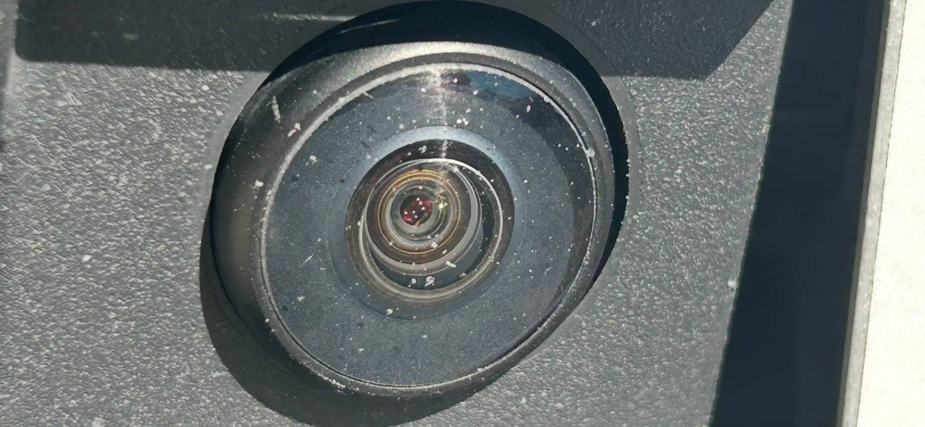 Tesla Cybertruck Front license plate camera glass getting worn from road stuff - any replacement or protection options? IMG_2881