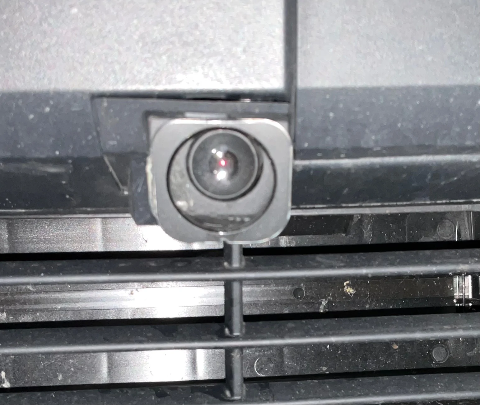 Tesla Cybertruck Front license plate camera glass getting worn from road stuff - any replacement or protection options? IMG_0606