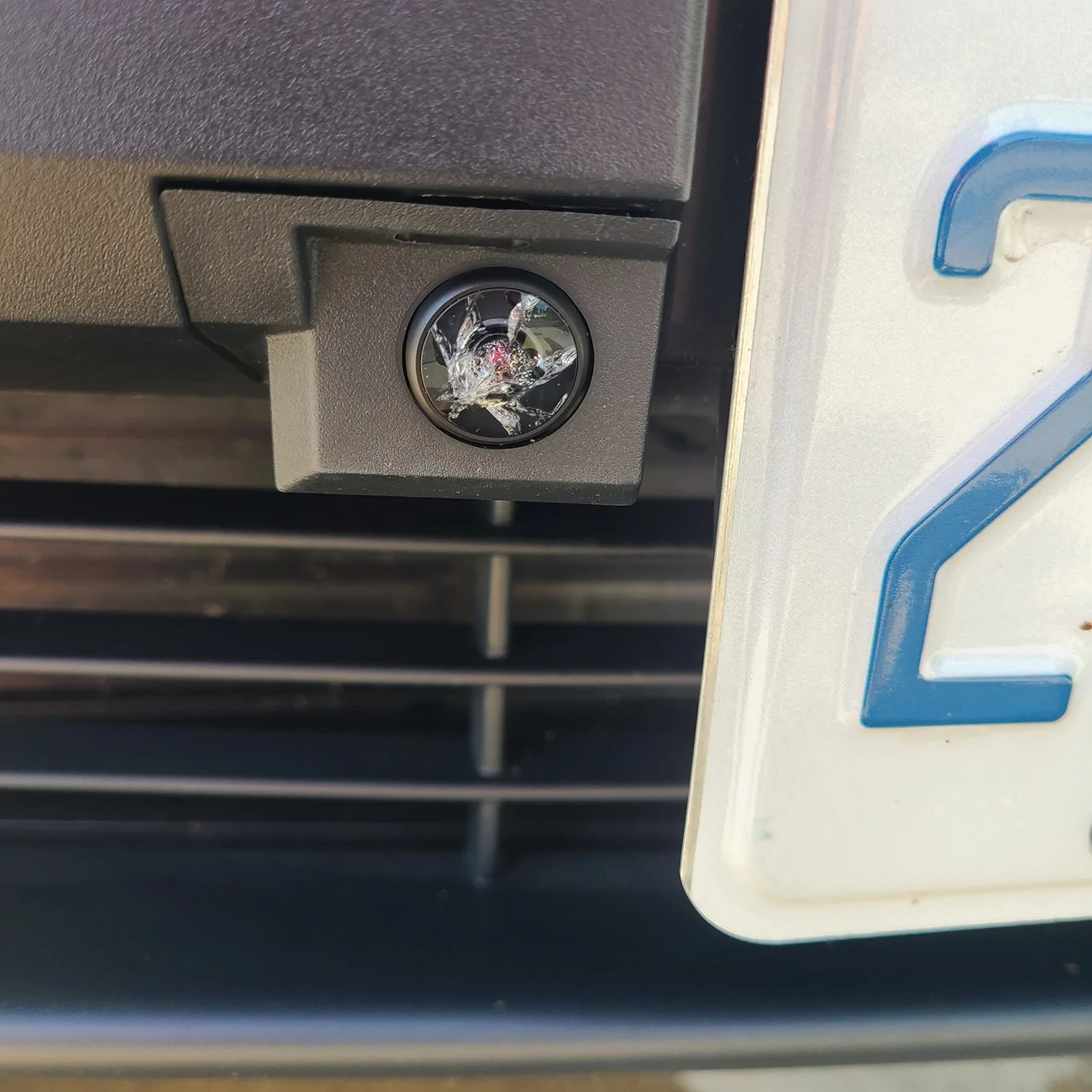 Tesla Cybertruck Front license plate camera glass getting worn from road stuff - any replacement or protection options? 20250830_160520