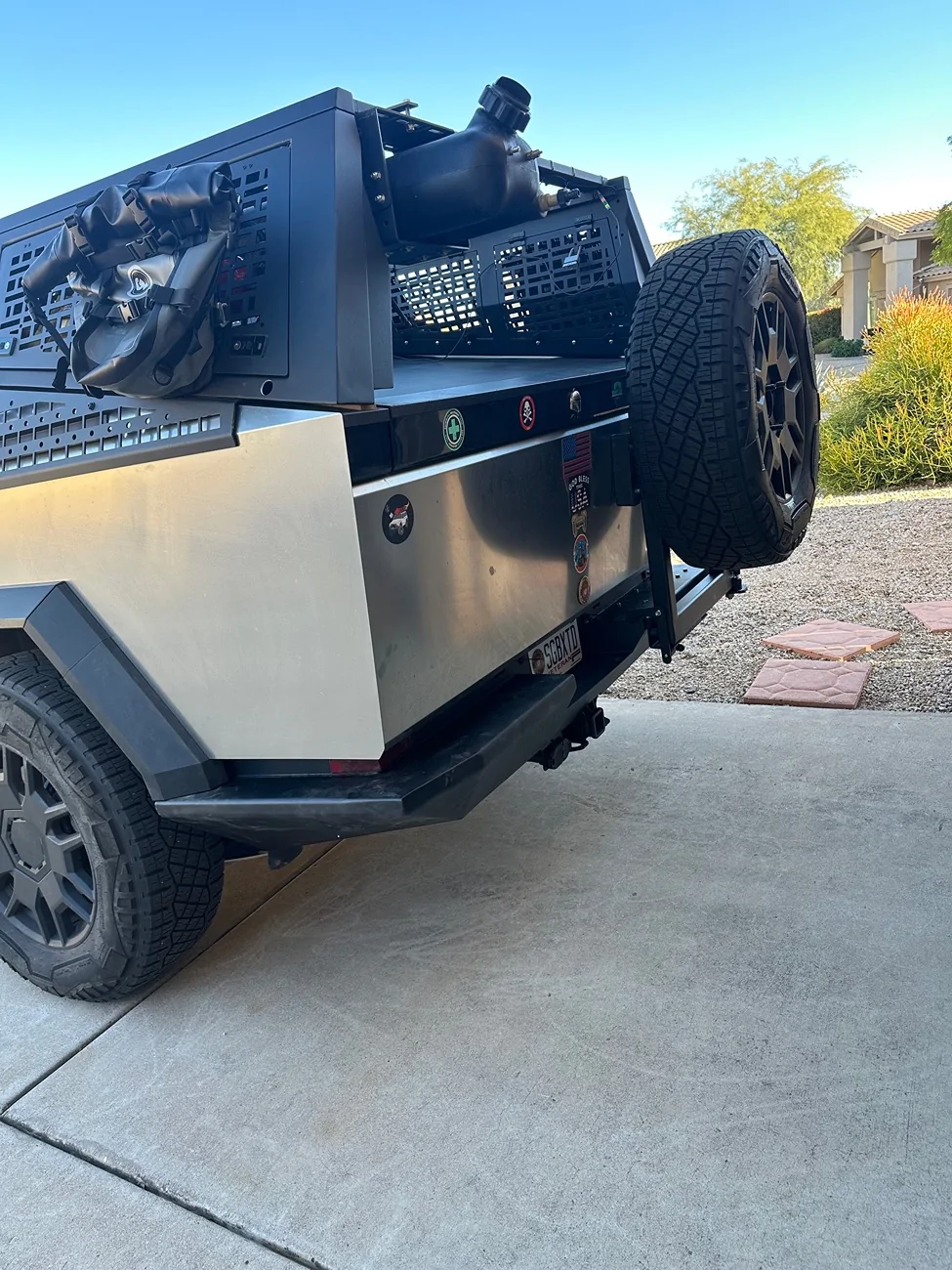 Tesla Cybertruck Spare tire storage idea: deflate it and stand it up in bed IMG_3666
