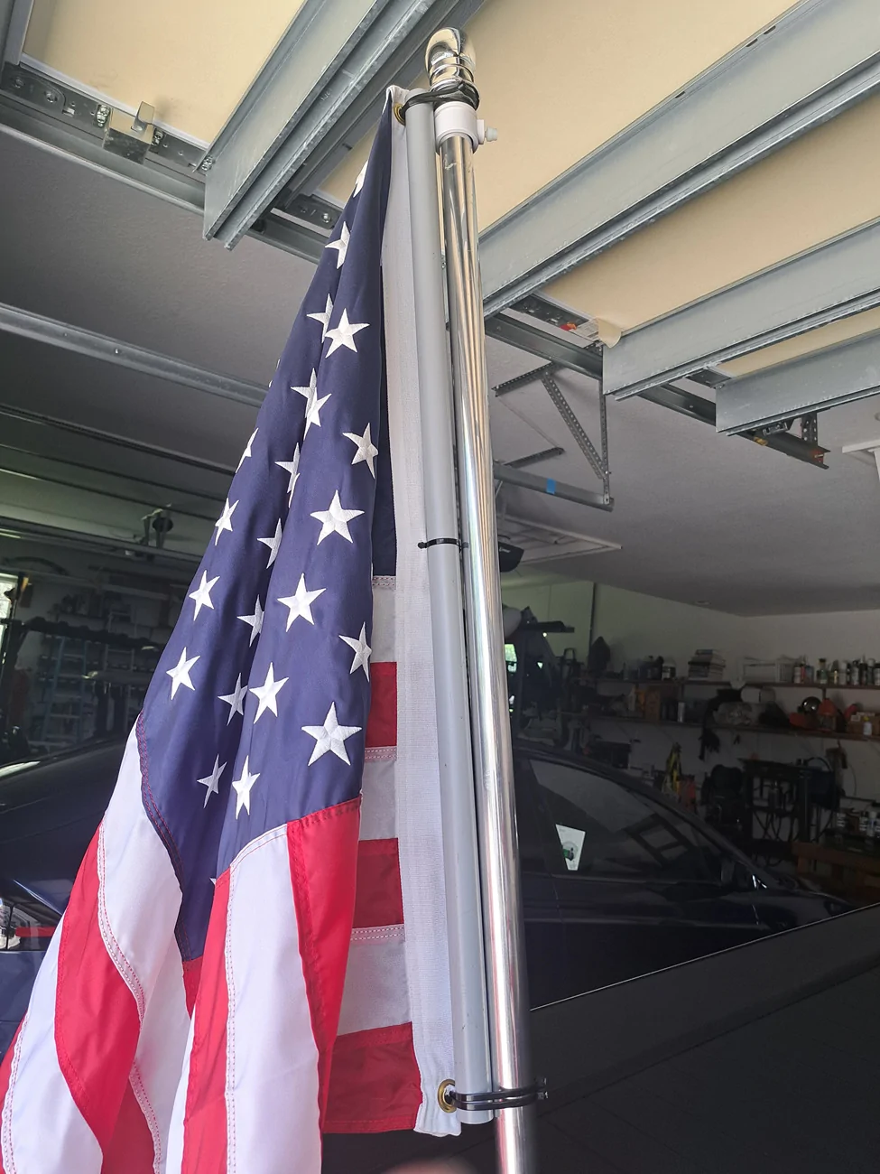 Tesla Cybertruck Flying American flags on Cybertruck - a solution using bed divider 20260703_145921