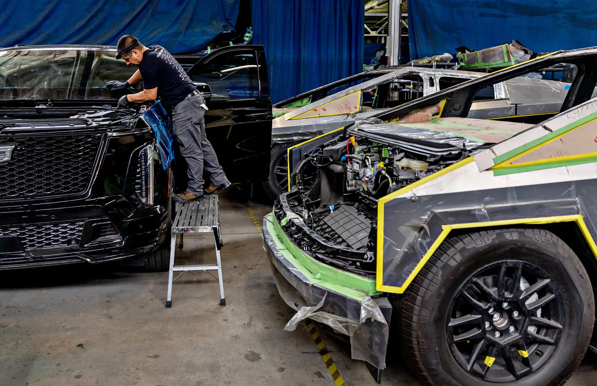 Tesla Cybertruck NY Times Story "Now on the American Road: Bulletproof Cars" shows 2 Cybertrucks getting Bullet Proof Glass 1784643903872-cd