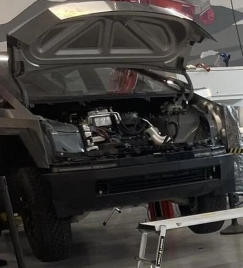 Tesla Cybertruck New leaked video! Many Cybertrucks production completed w/ new wheel design + finished frunks! Screenshot of Cybertruck wrapped like a F150, also sneak peak under the frunk. _ Tesla Motors
