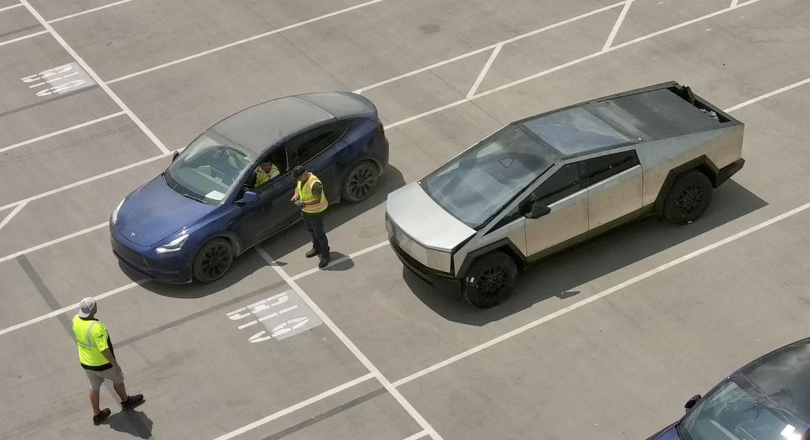 Tesla Cybertruck Photo: Frunk and Vault Bed partially open on Cybertruck (and next to Model Y) cybertruck frunk vault bed