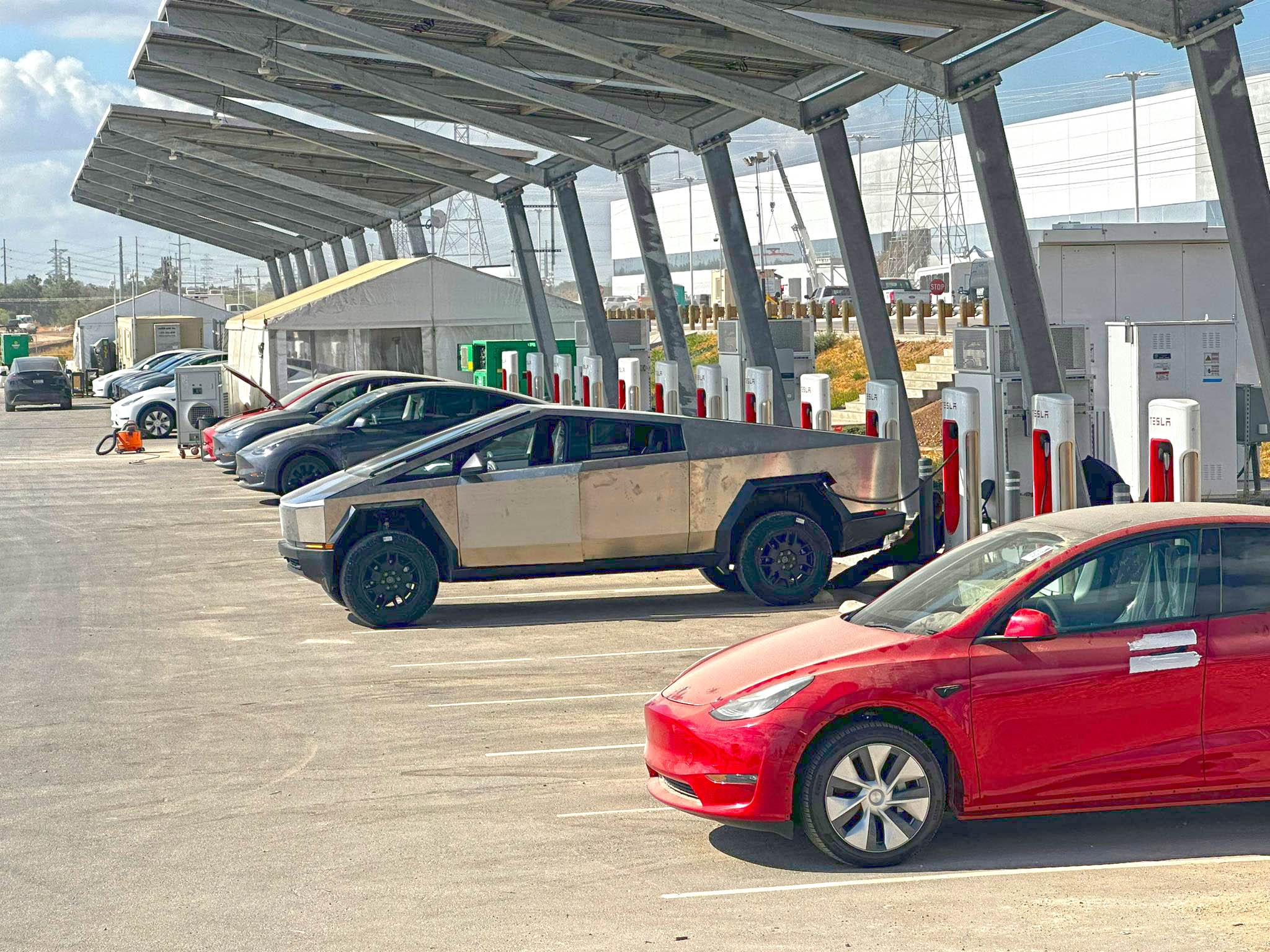 Tesla Cybertruck Cybertruck in raised suspension height supercharging at Giga Texas [9/9 pics] tesla cybertruck raised suspension supercharging 