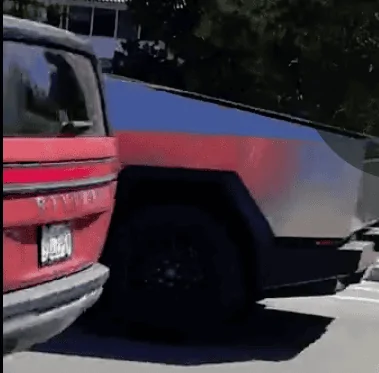 Tesla Cybertruck Cybertruck parked next to Rivian R1T and driving next to R1S 1695954331794