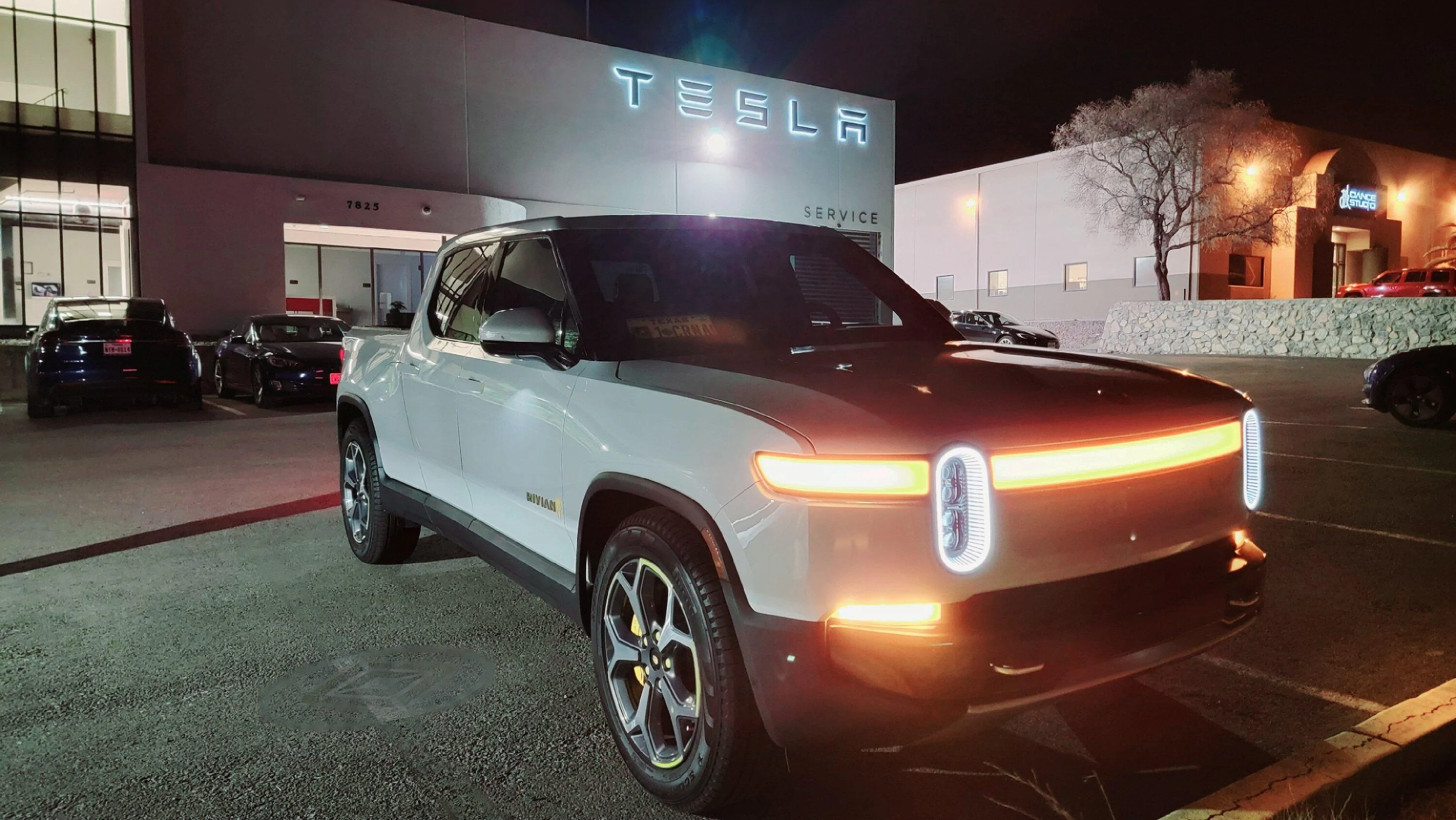 Tesla Cybertruck Cybertruck parked next to Rivian R1T and driving next to R1S 20221220_191502