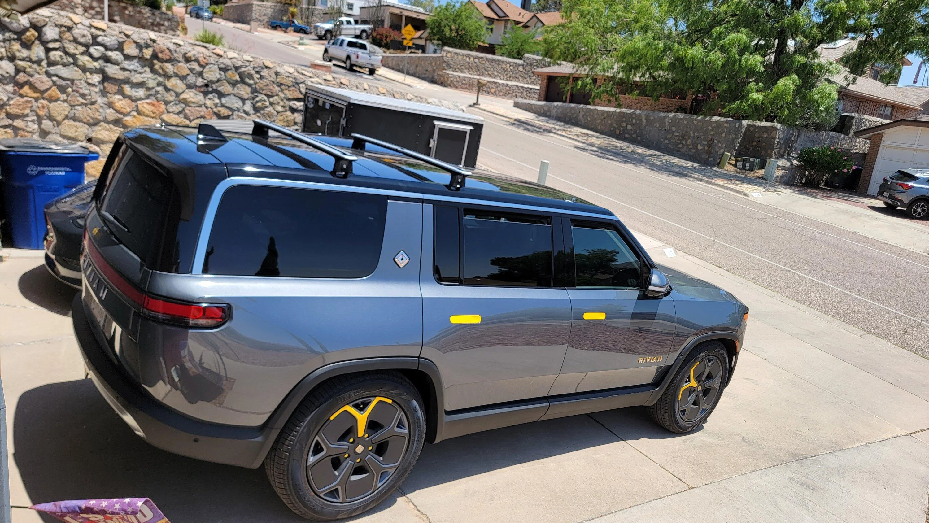 Tesla Cybertruck Cybertruck parked next to Rivian R1T and driving next to R1S 20230605_115415