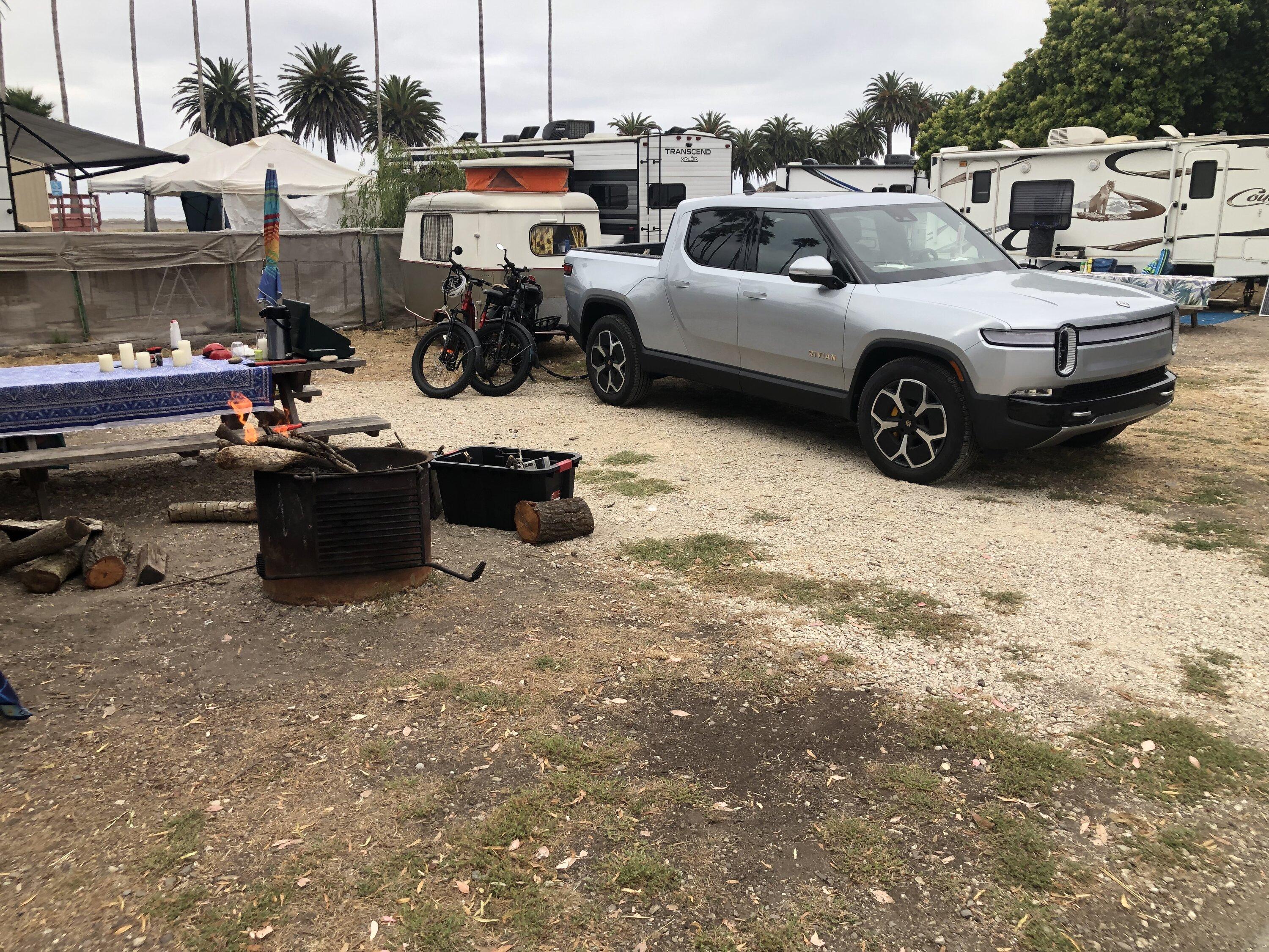 Tesla Cybertruck Cybertruck parked next to Rivian R1T and driving next to R1S IMG_0486