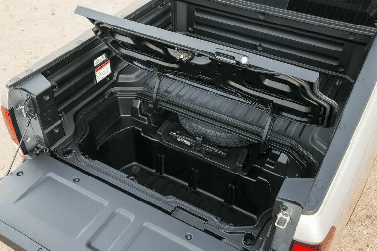 Tesla Cybertruck Cybertruck bed fully exposed w/ look at storage compartment cubby and LED lighting 1698950884987