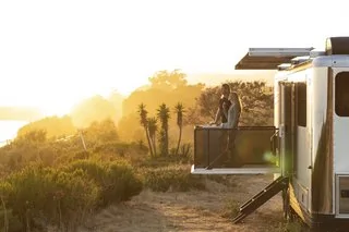 Tesla Cybertruck These Off-Grid, Luxury Travel Trailers Pack Enough Oomph to Power a Tesla Cybertruck from-the-side-of-the-vehicle-in-less-than-a-minut