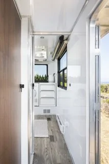 Tesla Cybertruck These Off-Grid, Luxury Travel Trailers Pack Enough Oomph to Power a Tesla Cybertruck ed-in-the-hallway-for-easy-access-from-the-outsid