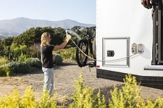 Tesla Cybertruck These Off-Grid, Luxury Travel Trailers Pack Enough Oomph to Power a Tesla Cybertruck r-and-placed-next-to-the-waterproof-fold-down-deck