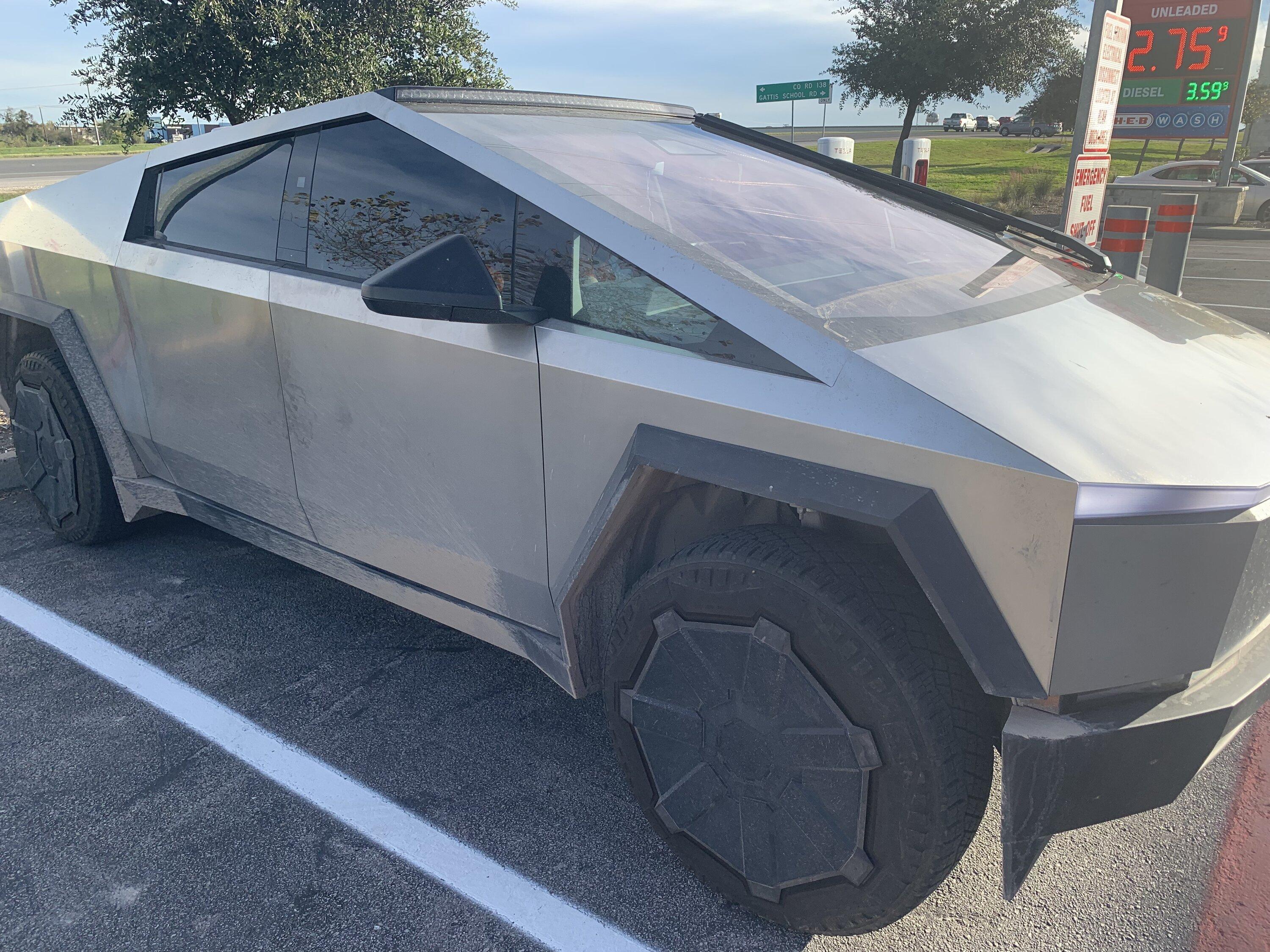 Tesla Cybertruck Cybertruck with LED light bar and in high suspension mode spotted at charging station img_0628-jpe