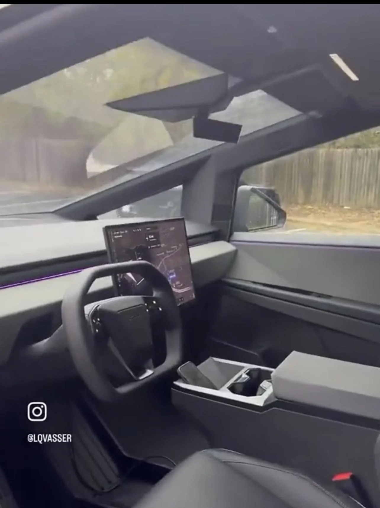 Tesla Cybertruck Cybertruck with LED light bar and in high suspension mode spotted at charging station 39775C49-FBC2-4820-AD0E-35B772B008A9