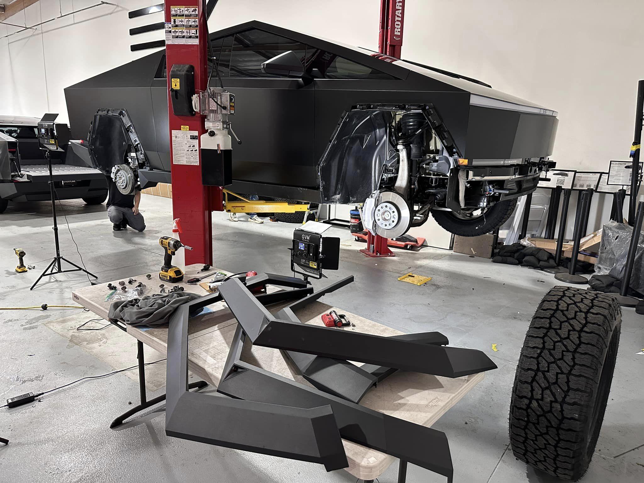 Tesla Cybertruck Cybertruck on a lift being modified at TSportline Tsportline Cybertruck upgrades parts modified modded build 1