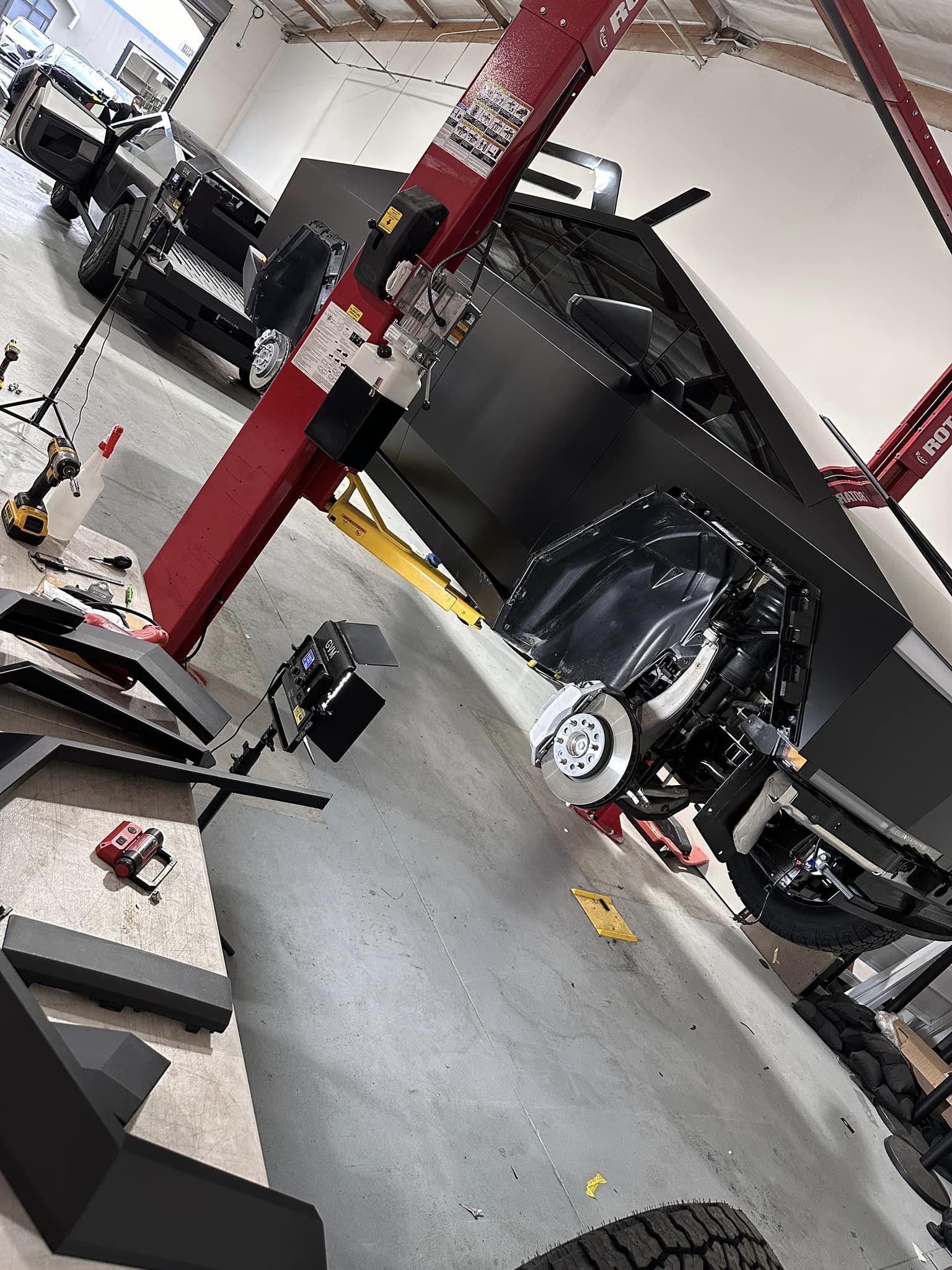 Tesla Cybertruck Cybertruck on a lift being modified at TSportline Tsportline Cybertruck upgrades parts modified modded build 2