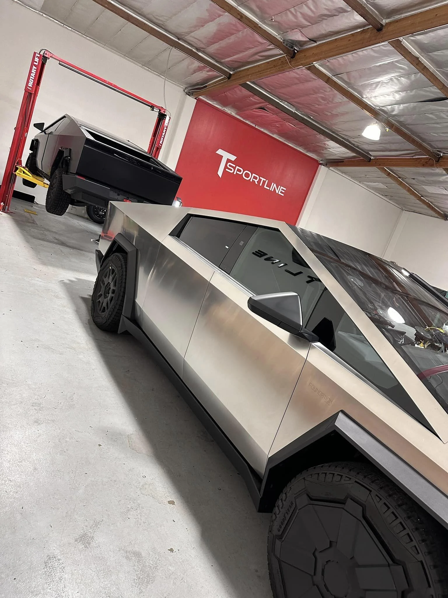 Tesla Cybertruck Cybertruck on a lift being modified at TSportline Tsportline Cybertruck upgrades parts modified modded build 3