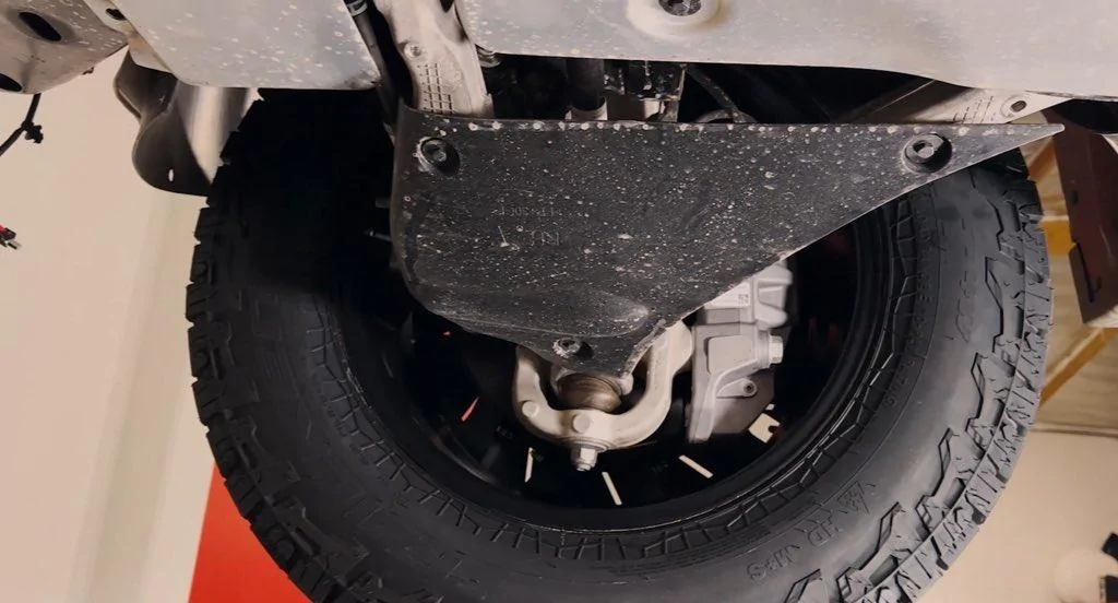 Tesla Cybertruck Dissecting a Cybertruck! Underbody, Chassis, Skid Plates Inspection & Walkthrough aero covers on lower control arms 3