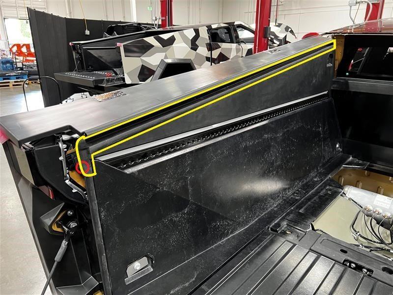 Tesla Cybertruck Kid dropped iPad down tonneau cover slit. 1713798630701-vi