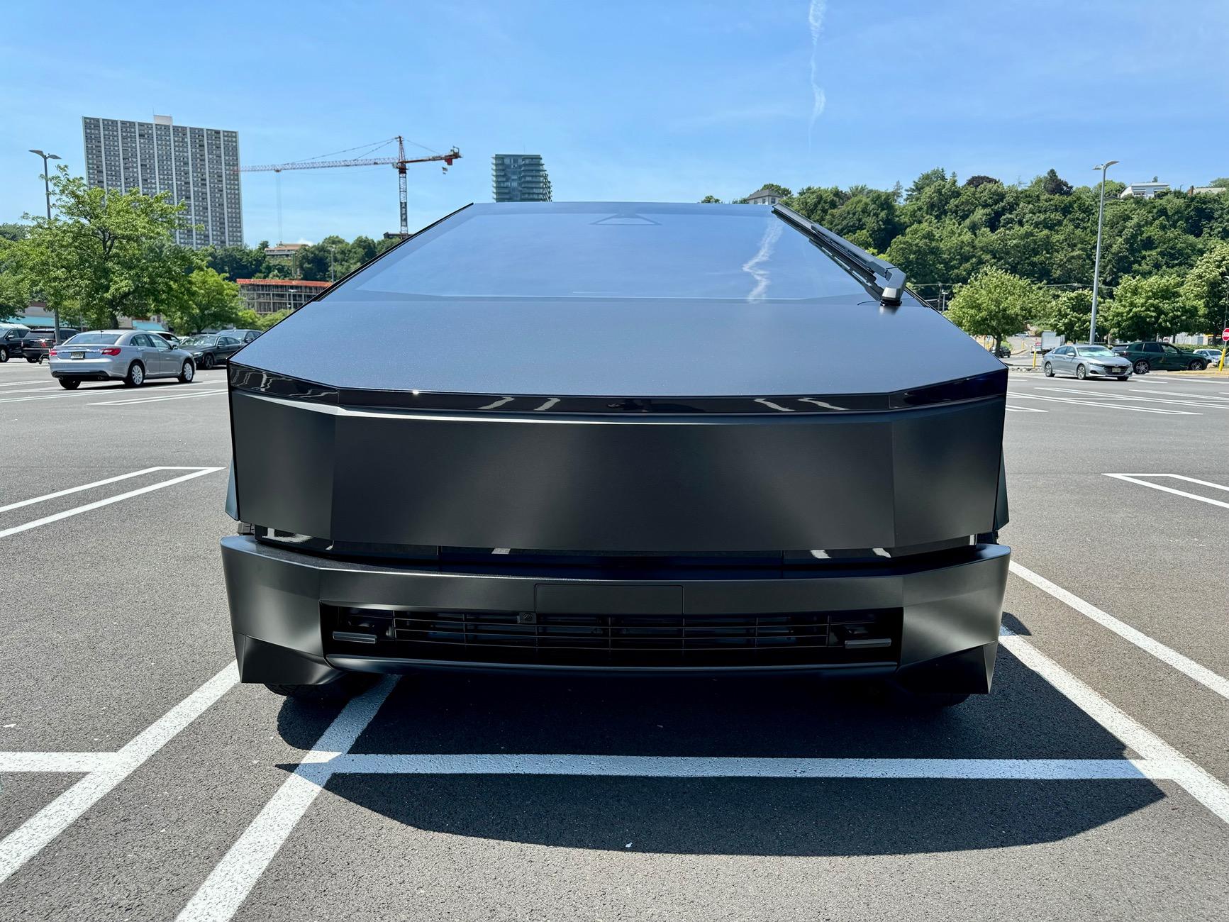 Tesla Cybertruck Satin Black Plasti Dip liquid wrapped body and plastics w/ all lights smoked out + gloss black liquid wrapped rims and red painted calipers IMG_1626