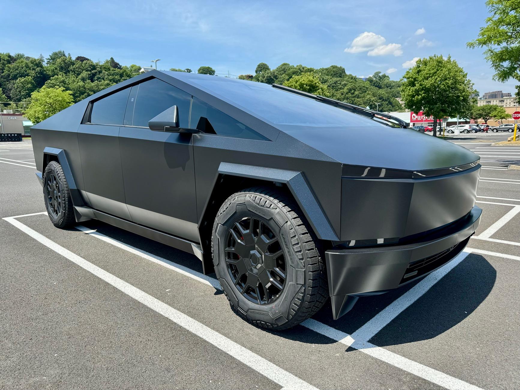 Tesla Cybertruck Satin Black Plasti Dip liquid wrapped body and plastics w/ all lights smoked out + gloss black liquid wrapped rims and red painted calipers IMG_1639