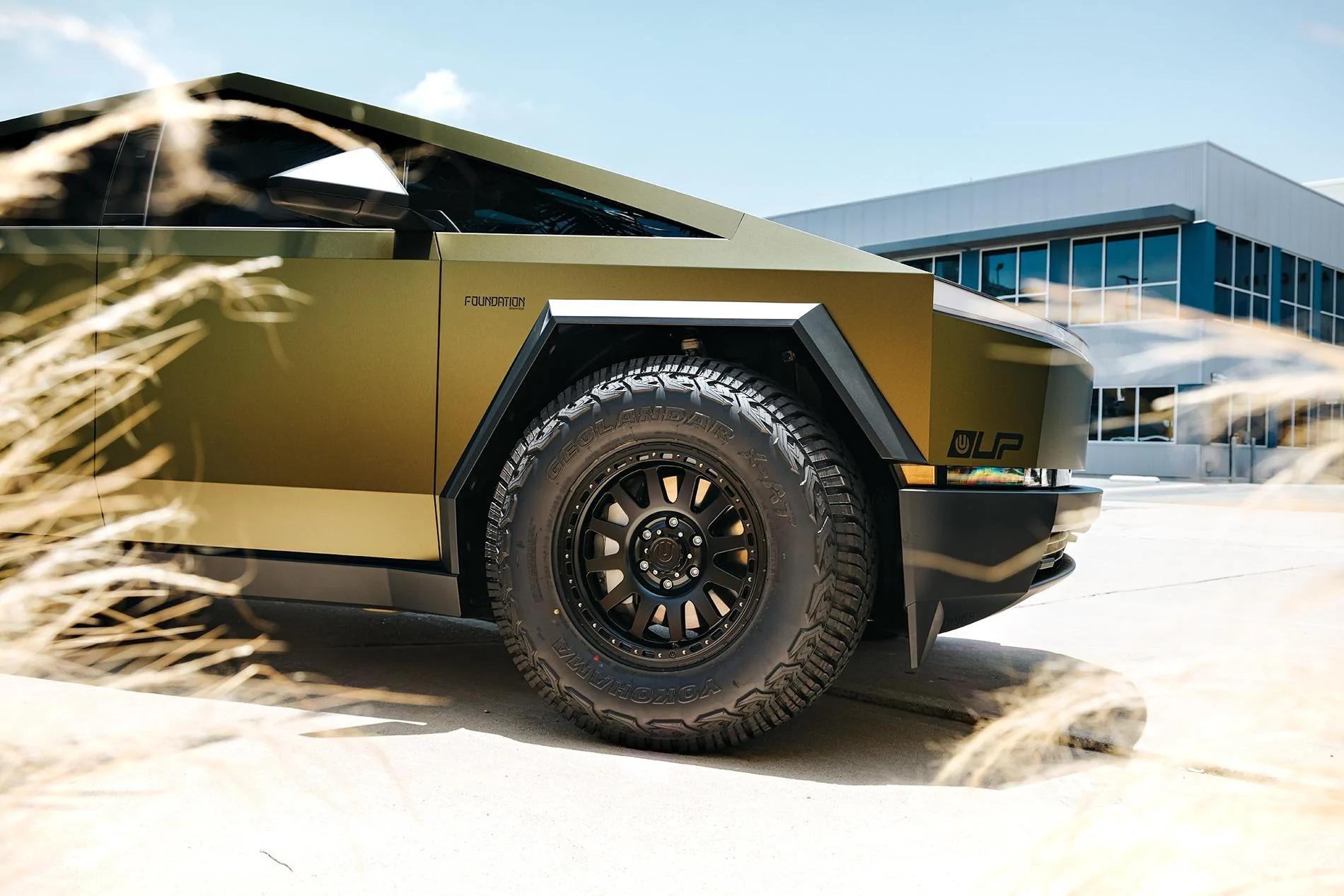 Tesla Cybertruck Unplugged Performance CyberBeast Goes Matte Gold + 18" Wheels (UP-03 Beadlocks) + Geolander 285/75/18 Tires Gold Tesla Cyberbeast - UP-03 Beadlock 18 inch Wheels in Satin Black by UP