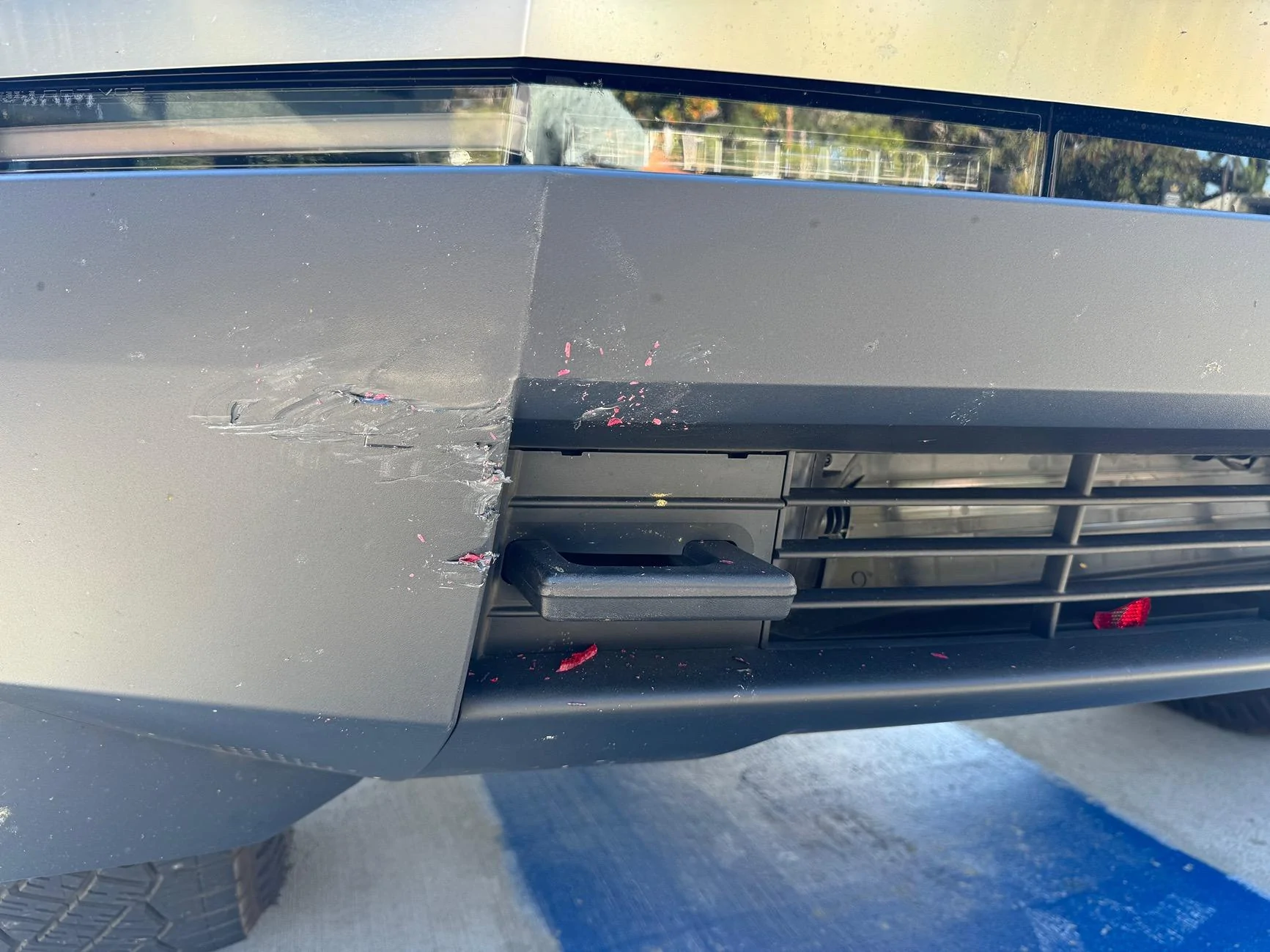 Tesla Cybertruck Front bumper hit in parking lot. Bumper replacement or repair? IMG_7628