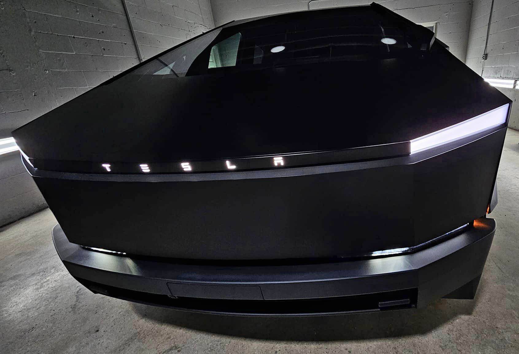 Tesla Cybertruck Black Cybertruck w/ blacked out (vinyl) front DRL light bar Tesla letters + Cyberbeast logo on tail lights Black Cybertruck w: blacked out (vinyl) front light bar & tinted rear light bar. Cyberbeast lo