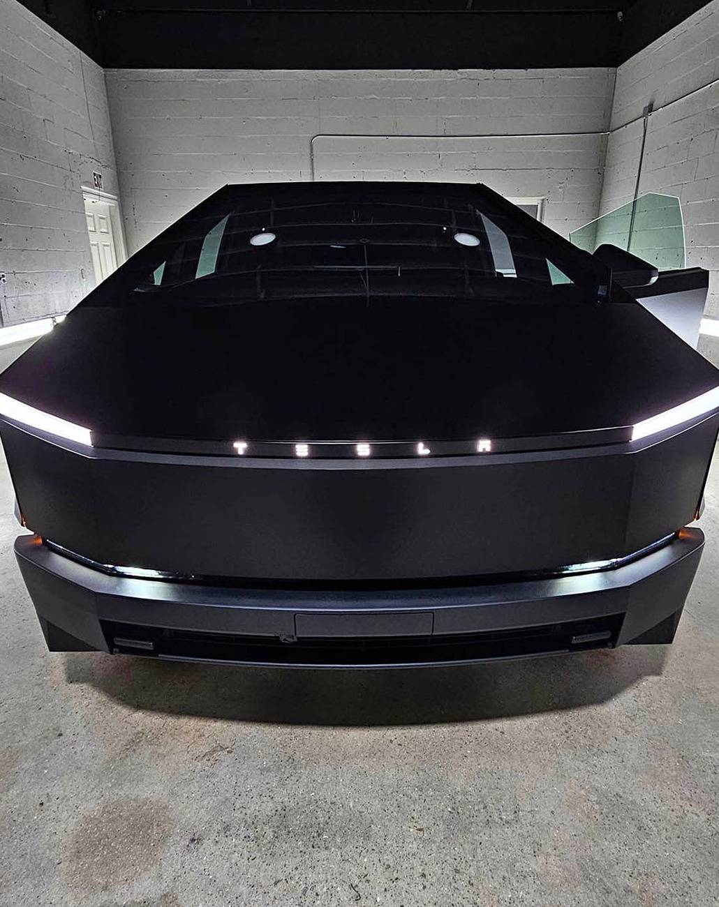 Tesla Cybertruck Black Cybertruck w/ blacked out (vinyl) front DRL light bar Tesla letters + Cyberbeast logo on tail lights Black Cybertruck w: blacked out (vinyl) front light bar & tinted rear light bar. Cyberbeast lo