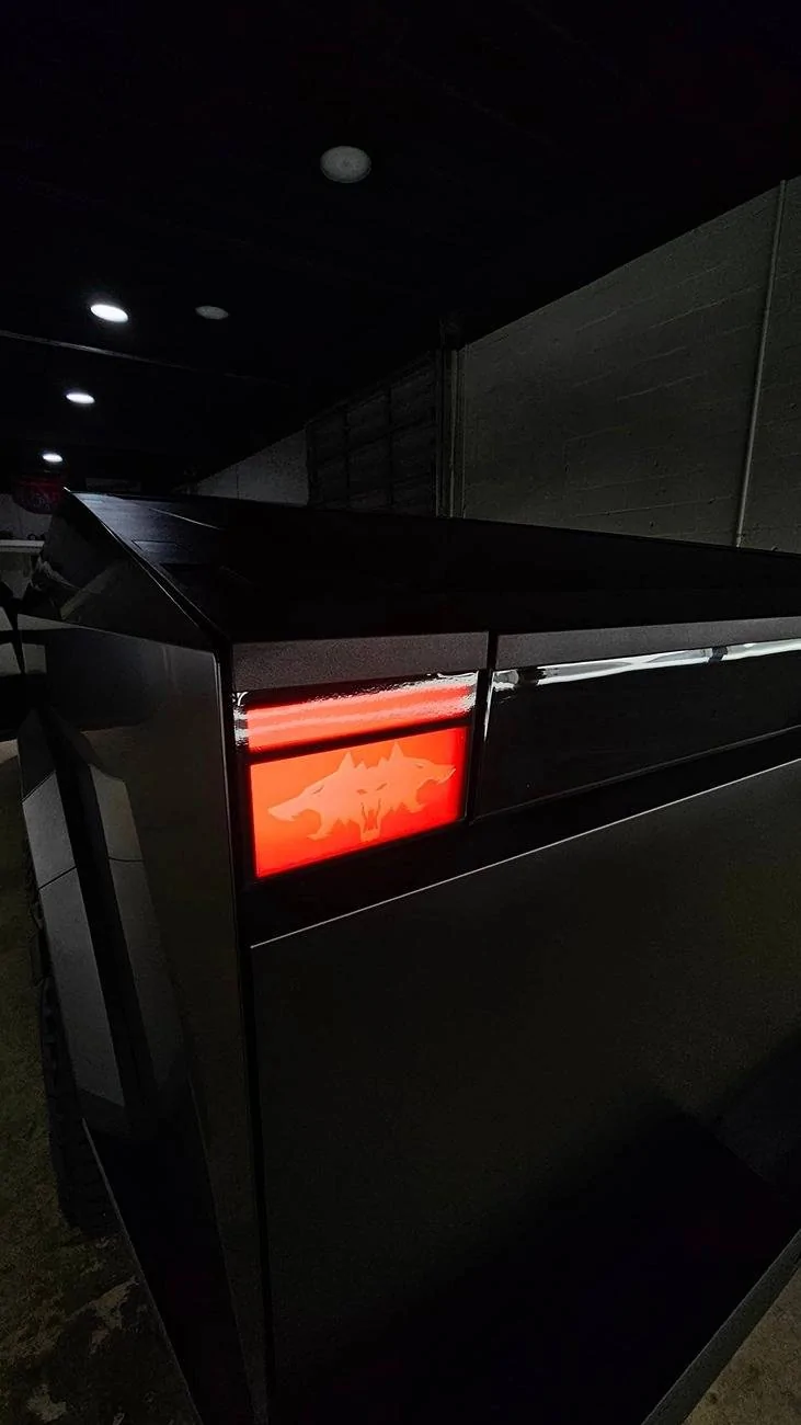 Tesla Cybertruck Black Cybertruck w/ blacked out (vinyl) front DRL light bar Tesla letters + Cyberbeast logo on tail lights Black Cybertruck w: blacked out (vinyl) front light bar & tinted rear light bar. Cyberbeast l