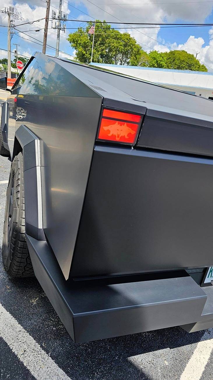 Tesla Cybertruck Black Cybertruck w/ blacked out (vinyl) front DRL light bar Tesla letters + Cyberbeast logo on tail lights Black Cybertruck w: blacked out (vinyl) front light bar & tinted rear light bar. Cyberbeast lo