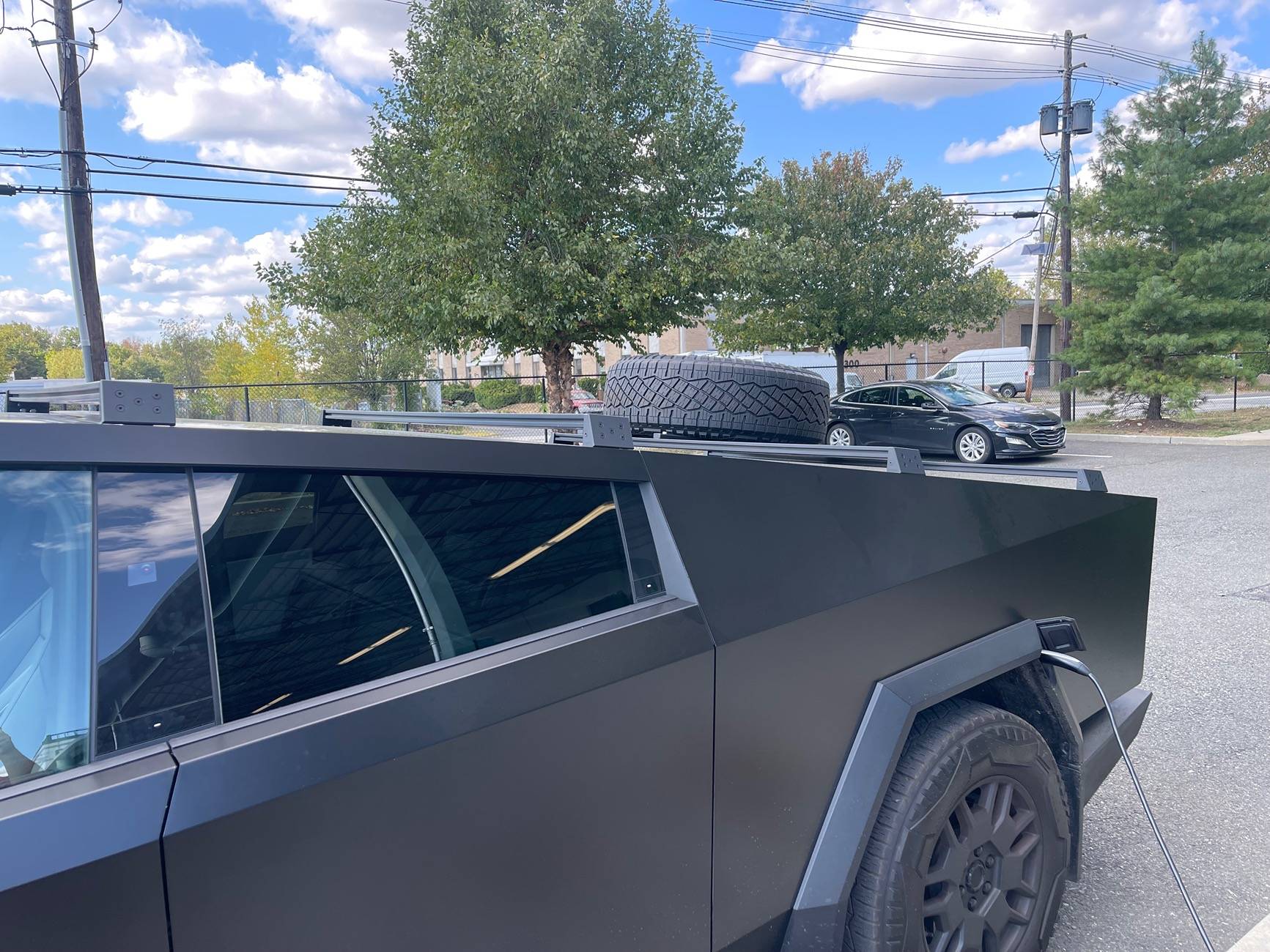 Tesla Cybertruck Spare tire roof rack installed on lower racks on my Cybertruck IMG_1339