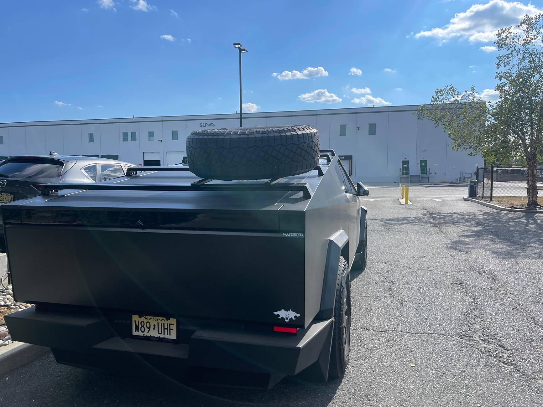 Tesla Cybertruck Spare tire roof rack installed on lower racks on my Cybertruck IMG_1337