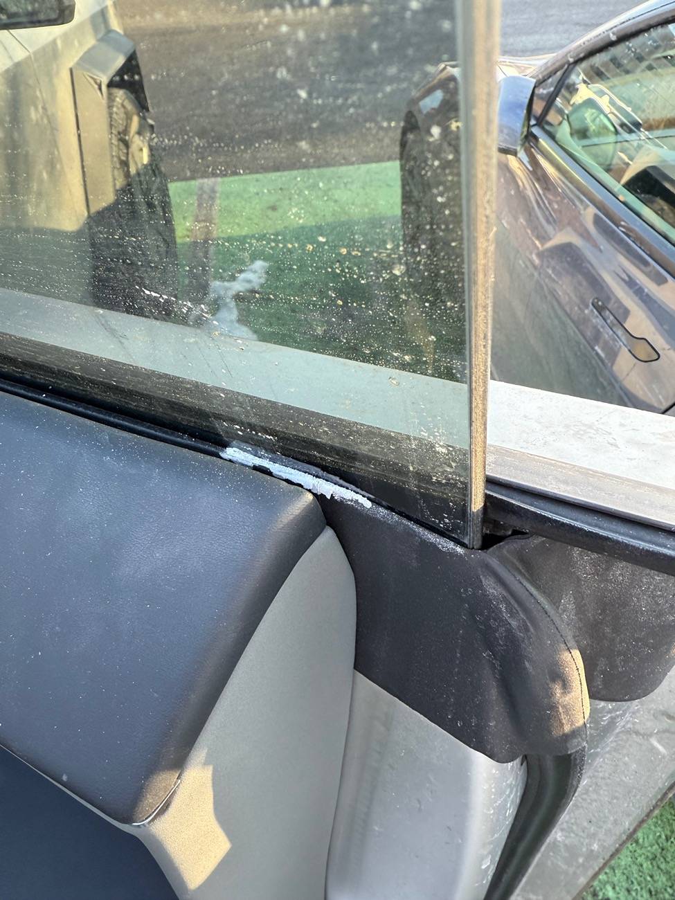 Tesla Cybertruck Weird white chalky powder deposit on inside of door glass seal IMG_5027
