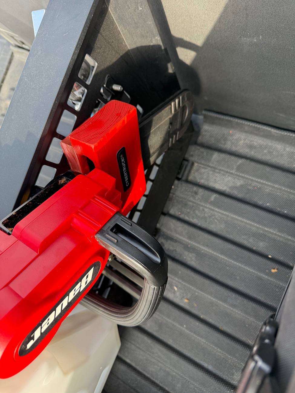 Tesla Cybertruck Chainsaw mount on cargo divider IMG_5539