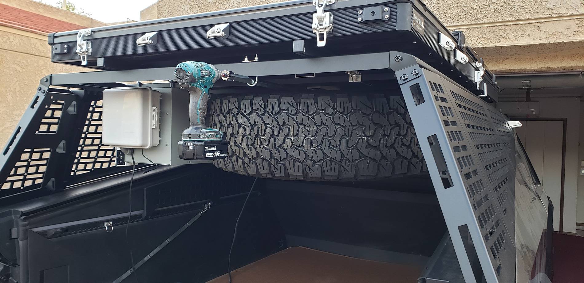 Tesla Cybertruck How I Carry a Spare When Off-road Adventuring -- Mounted to Underside of Bed Rack Driver