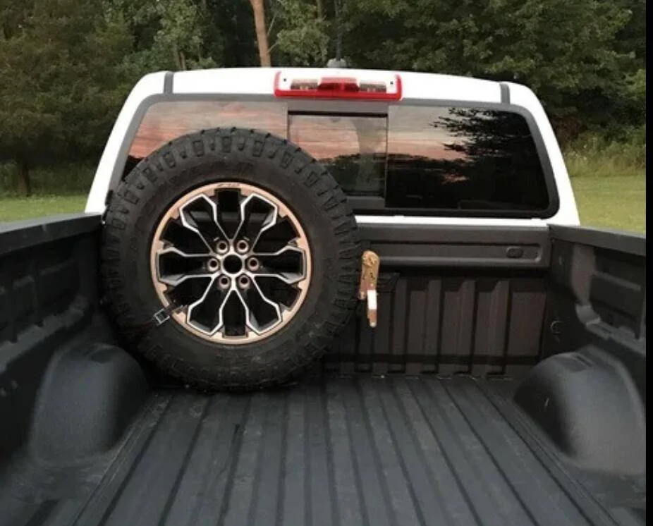 Tesla Cybertruck How I Carry a Spare When Off-road Adventuring -- Mounted to Underside of Bed Rack Screenshot 2025-02-21 at 06.41.11
