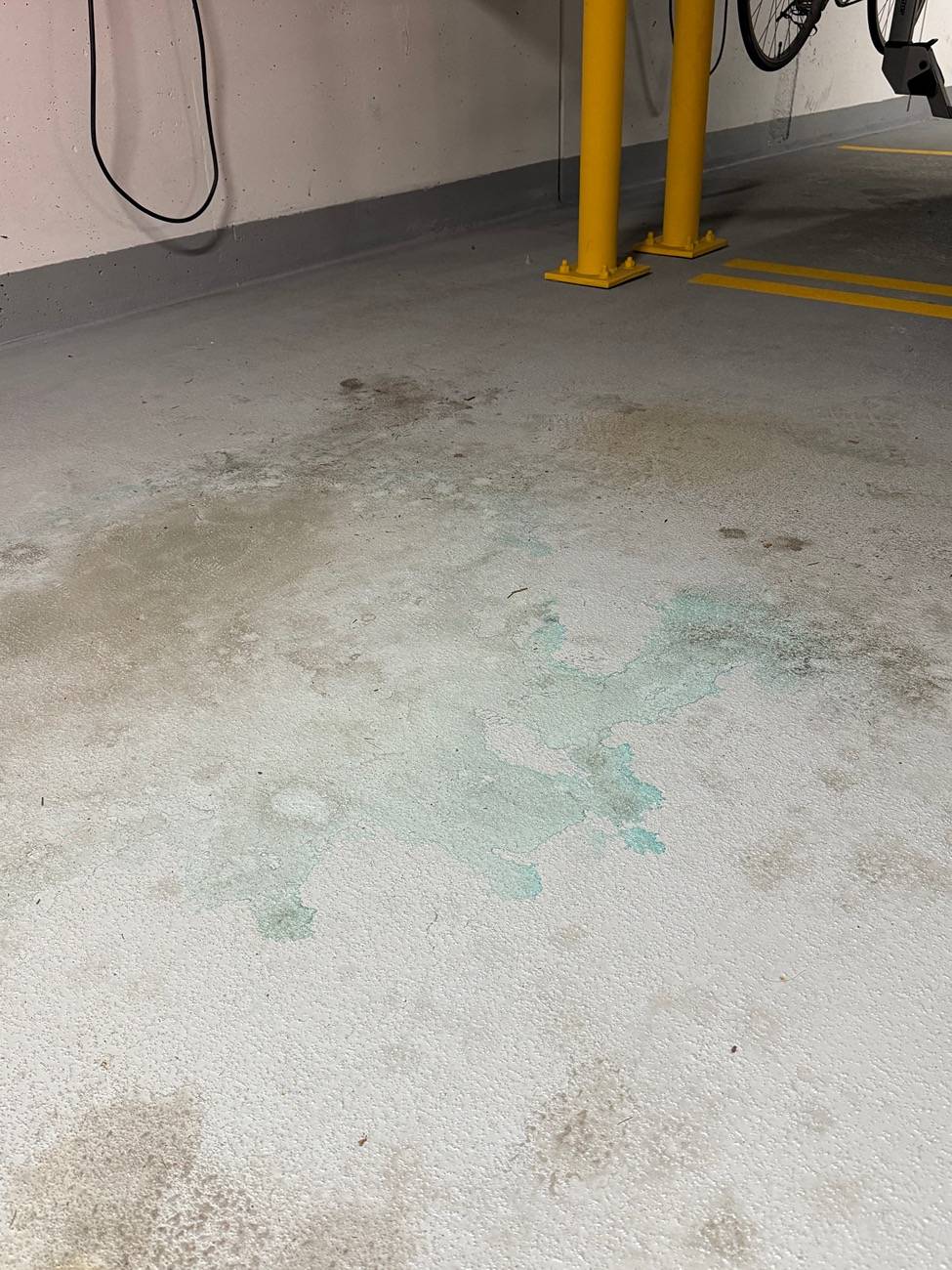 Tesla Cybertruck Dried blue substance on garage floor under rear axel IMG_4256