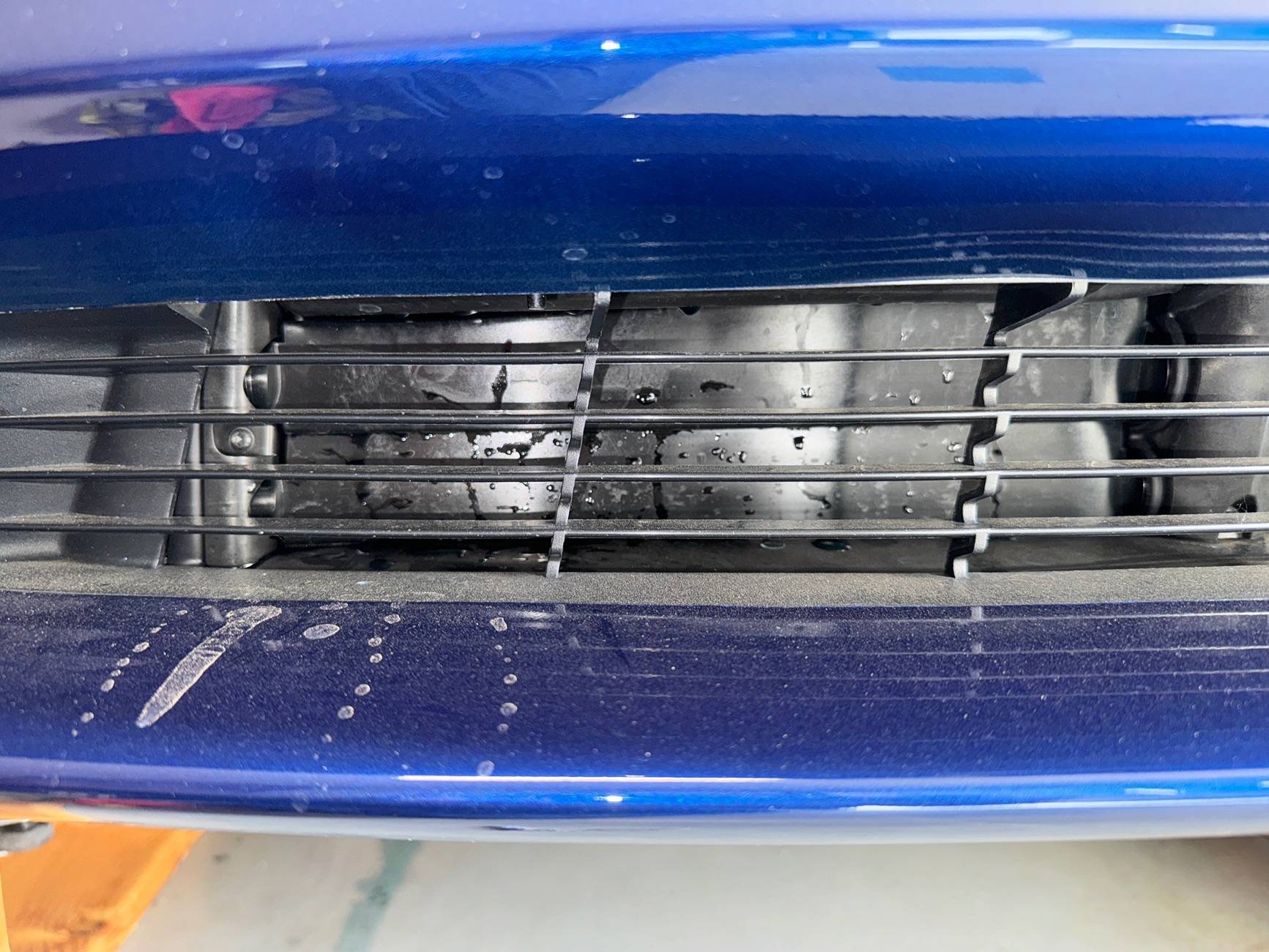 Tesla Cybertruck Dried blue substance on garage floor under rear axel IMG_7641
