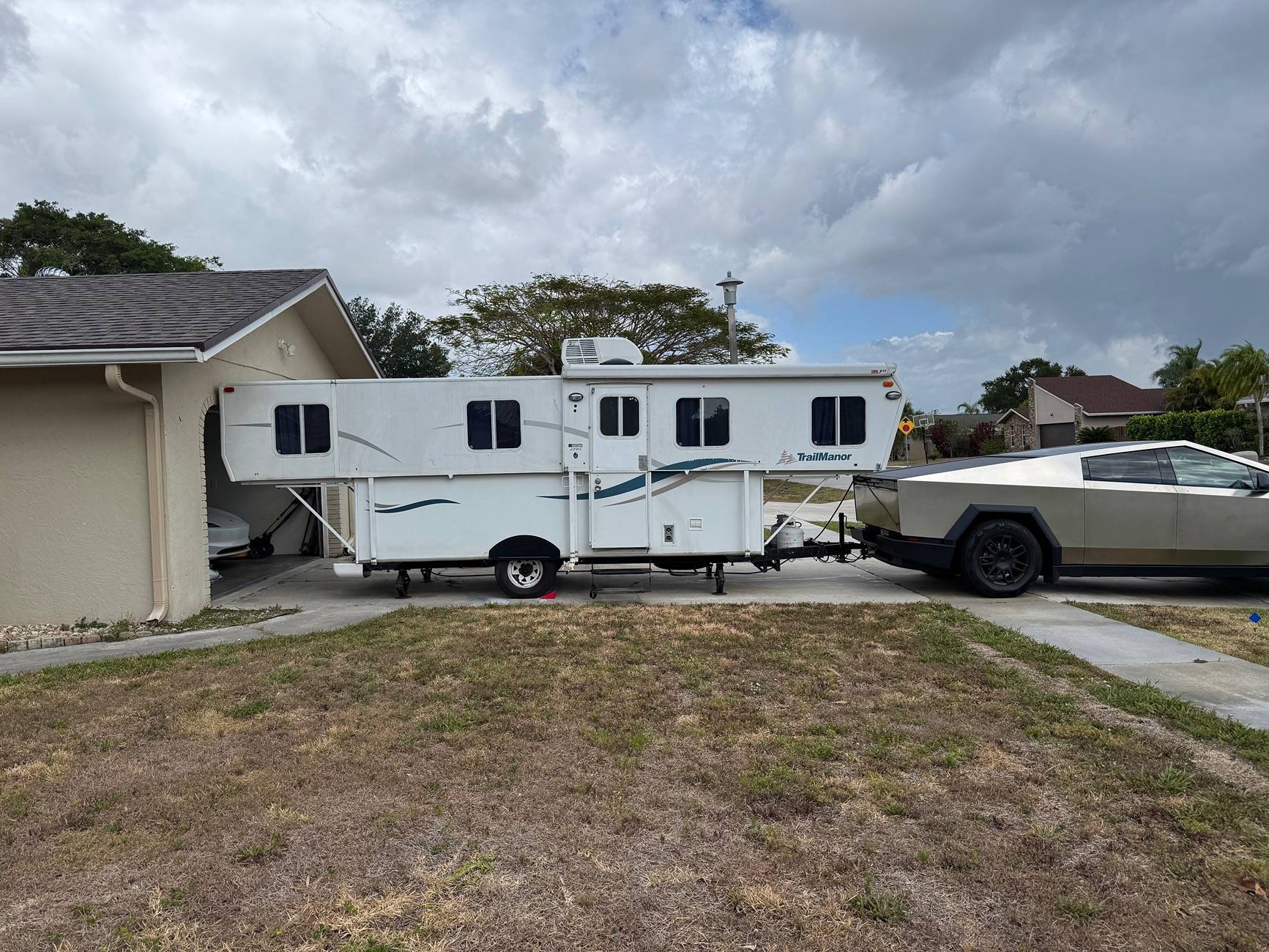 Tesla Cybertruck Just got a Trailmanor hard shell pop up camper -- towing stats IMG_2122