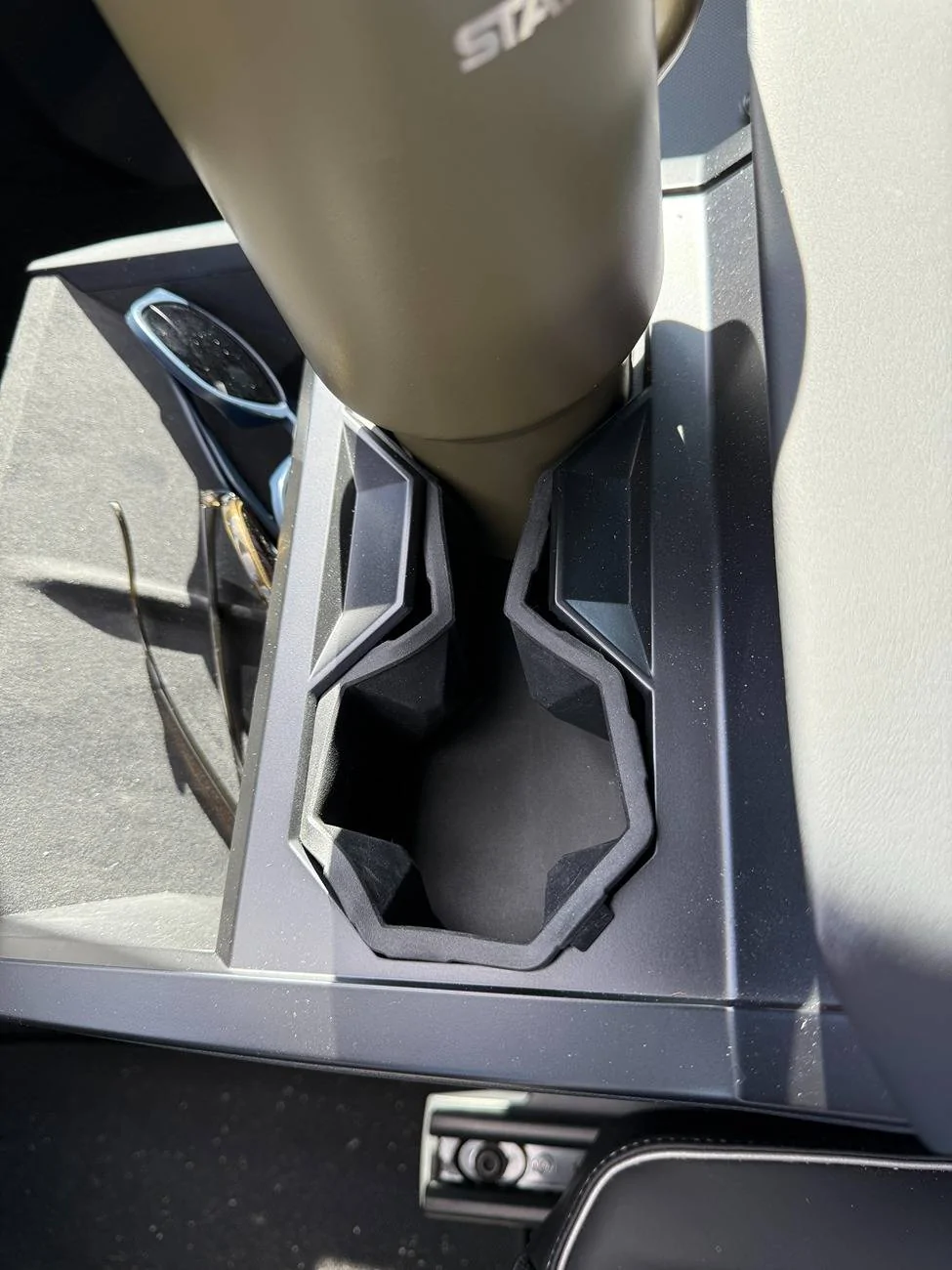 Tesla Cybertruck Recurring "CRITICAL SAFETY!!!" issue with rear wheel alignment. Side note: WTF is up with the cupholders?? IMG_4014
