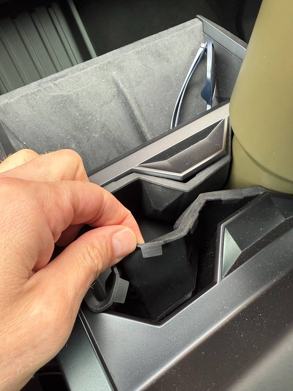 Tesla Cybertruck Recurring "CRITICAL SAFETY!!!" issue with rear wheel alignment. Side note: WTF is up with the cupholders?? IMG_4021
