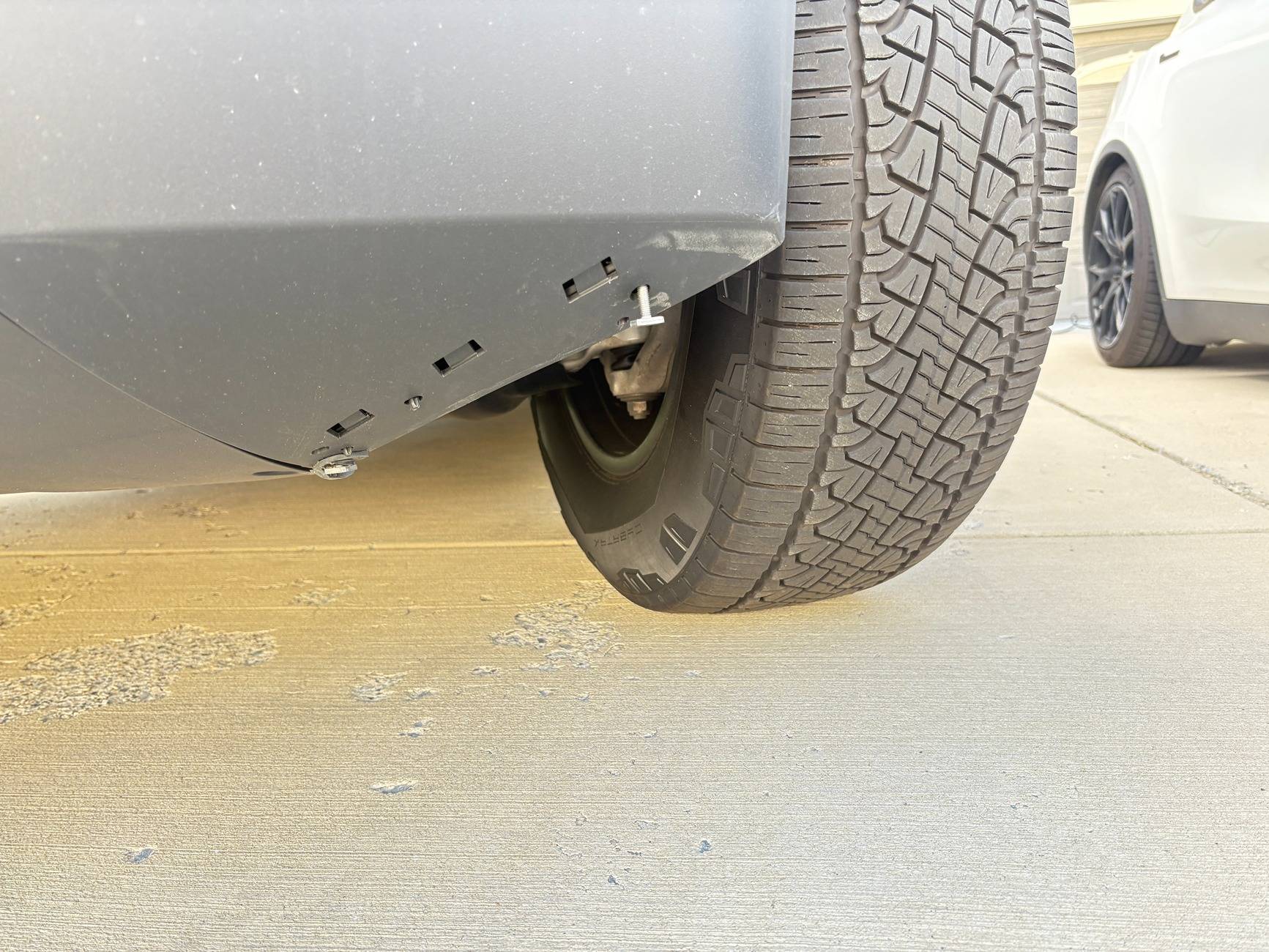 Tesla Cybertruck OEM mud flaps for the front of the tire missing. Where can I buy them? IMG_2223.JPG