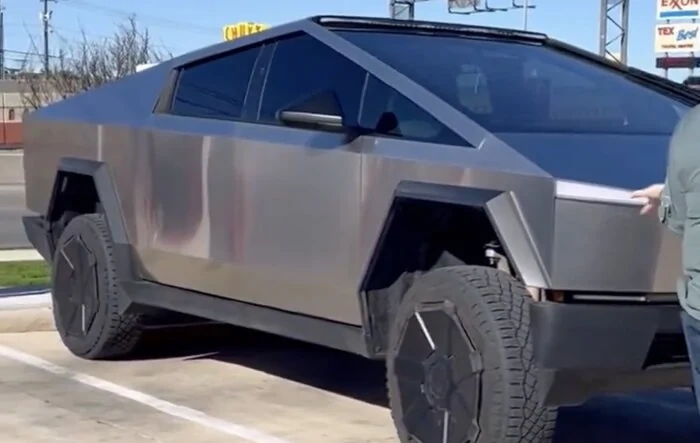Cybertruck with LED light bar and in high suspension mode spotted at charging station