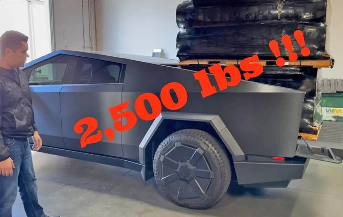 Load testing: 2,500 lbs loaded into Cybertruck bed. Auto-leveling in action