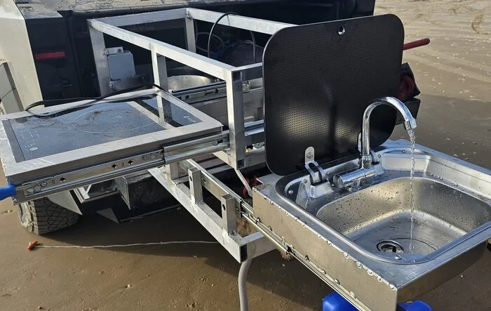 Custom Cybertruck camp kitchen with grill and sink