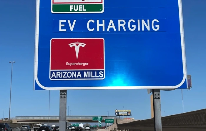 Tesla Superchargers begin appearing on US highway signs (next to gas stations)